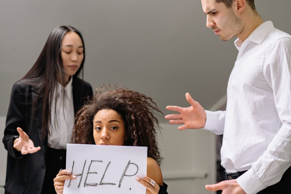 Woman holding help card at work